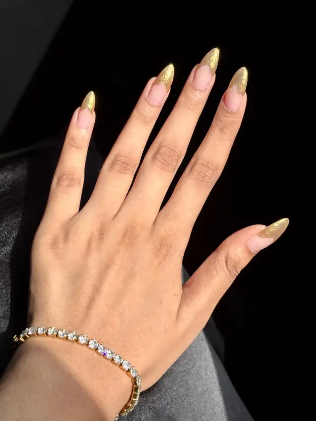 Gold chrome stiletto nail extensions