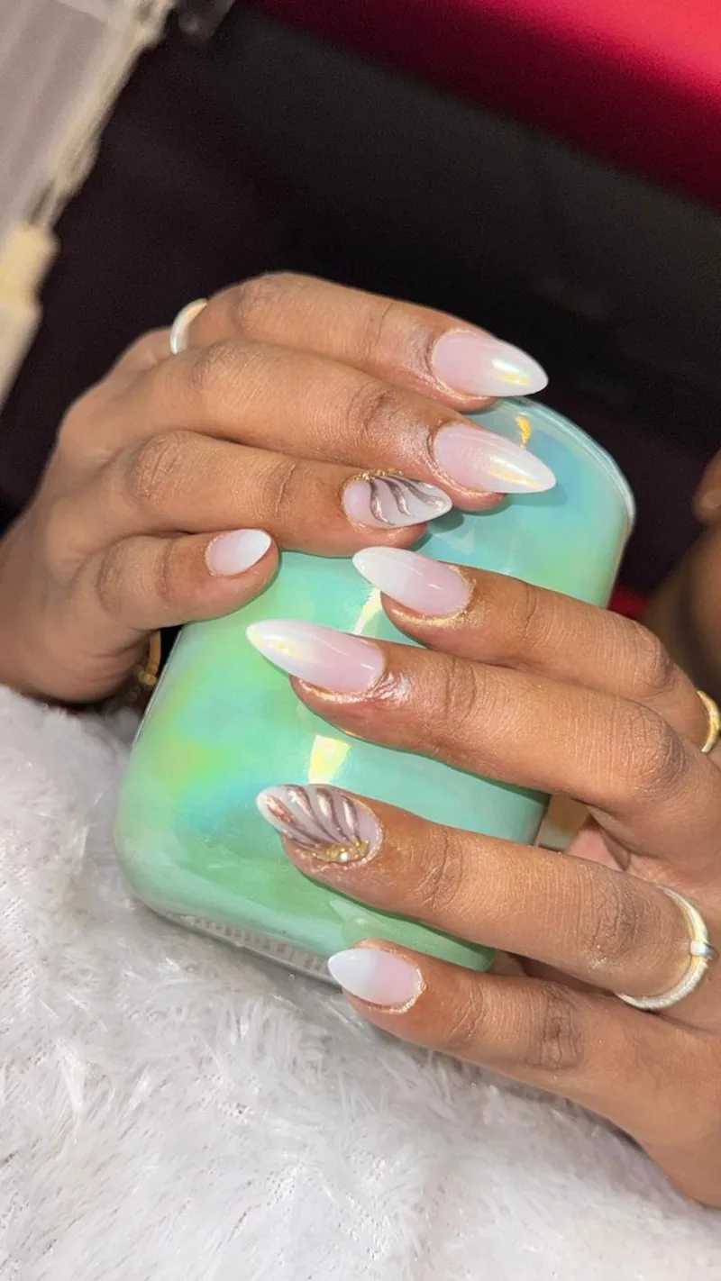 Iridescent pearl gel nails with gold swirl art