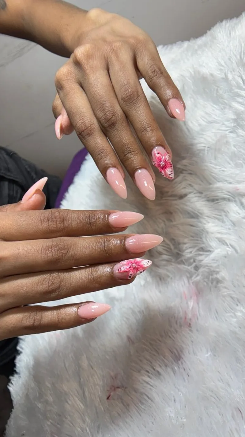 Nude pink almond nails with hand-painted floral art