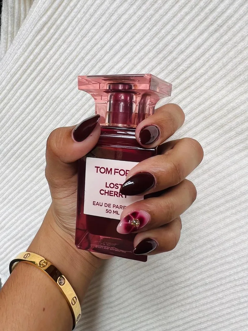 Deep burgundy almond nails with cherry marble accent