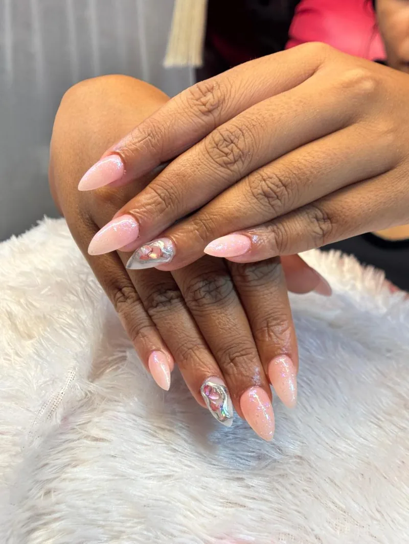 Almond pink glitter gel nails with iridescent shell accent