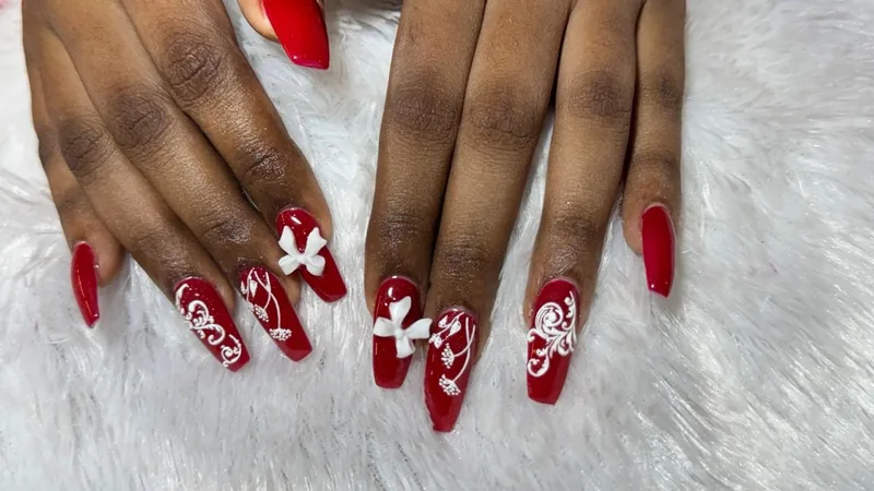 Red coffin nails with white lace art and 3D bows